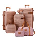 Gold-tone ribbed luggage collection with pink travel bag and pouch
